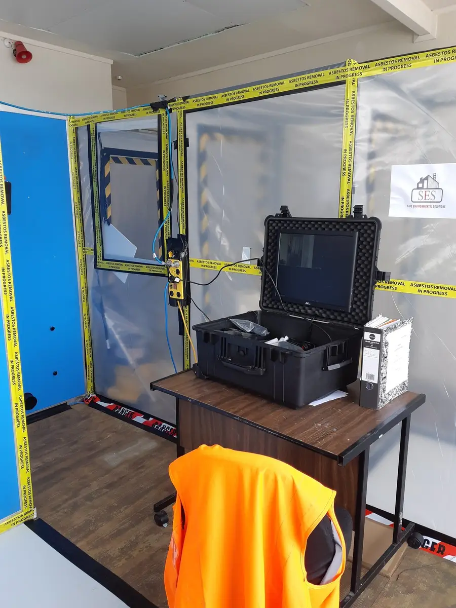 Air monitoring equipment beside the decontamination unit and enclosure