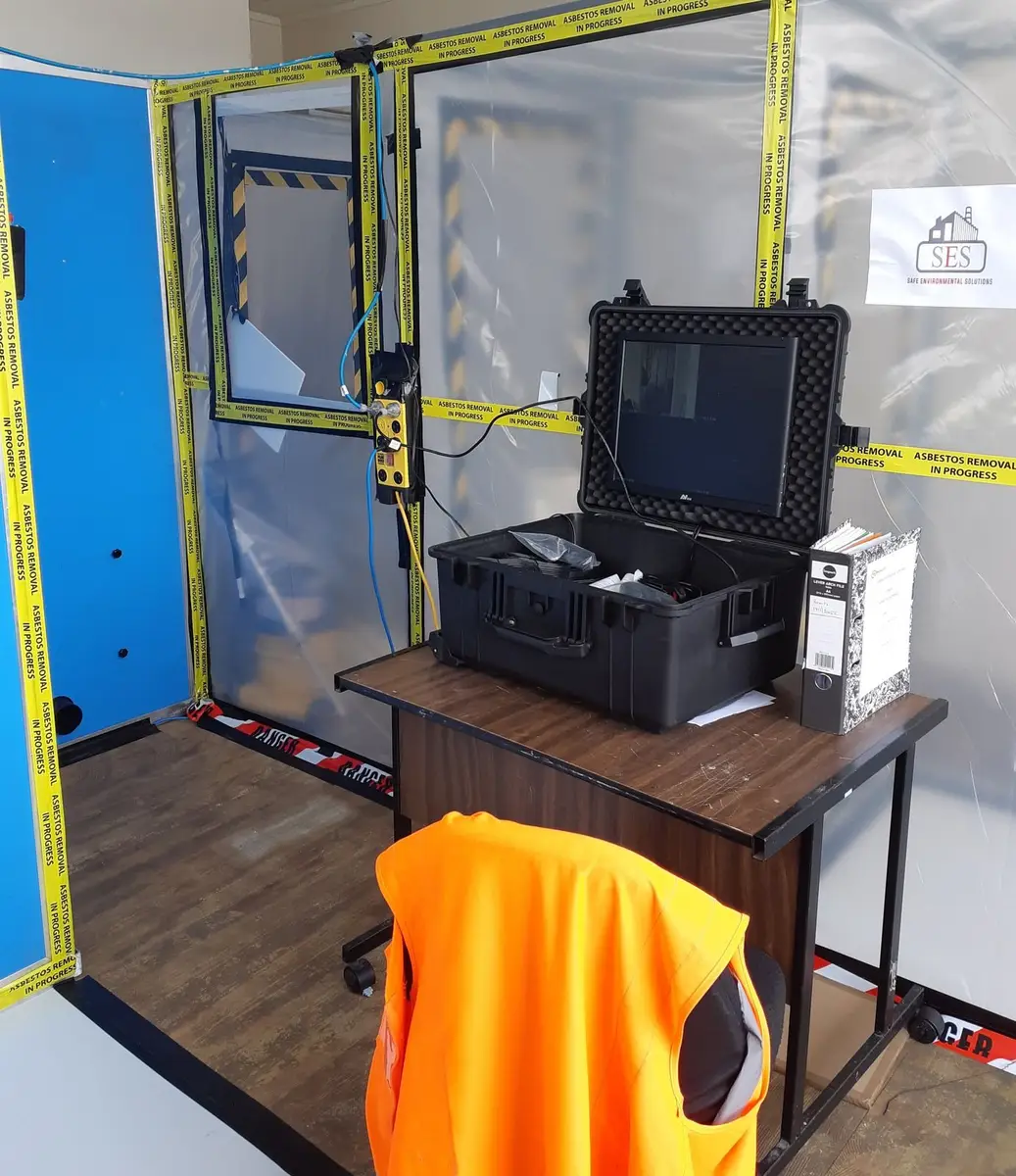 Air monitoring kit on a table beside the decontamination unit