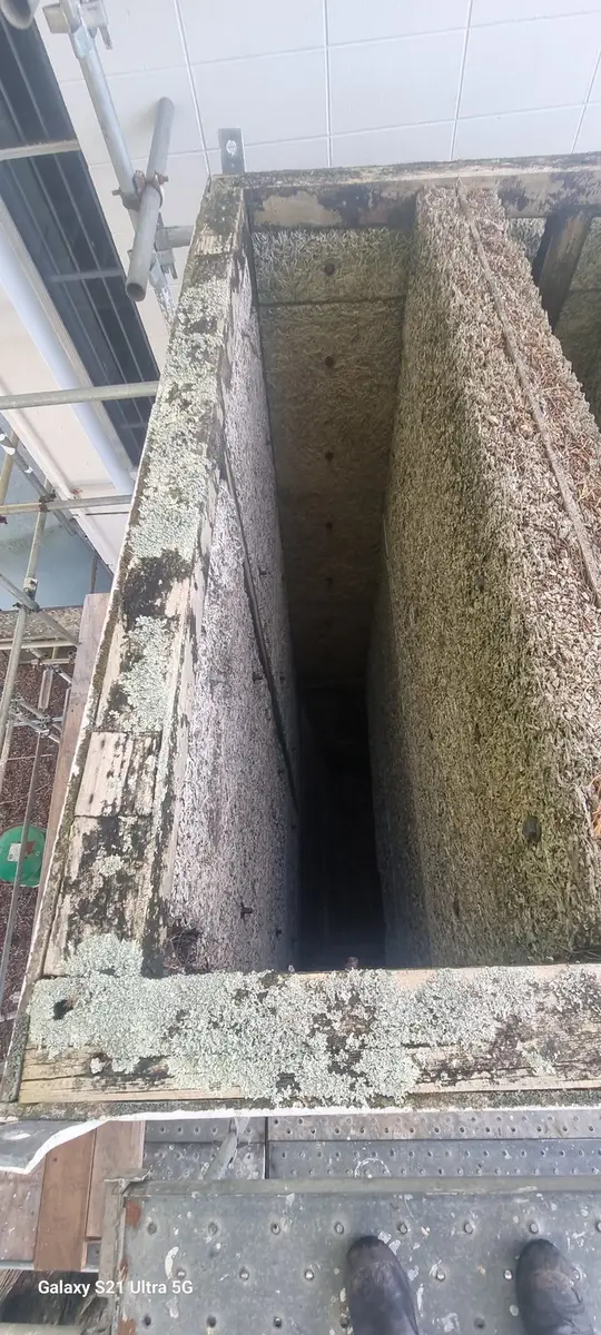 Looking down the asbestos-cement duct shaft before dismantling