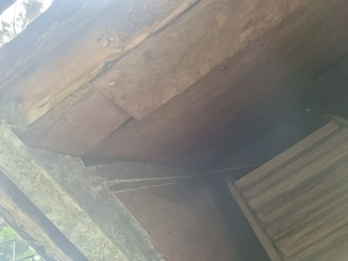 Underside of the asbestos-cement hood showing the timber louvre and fibre-cement lining