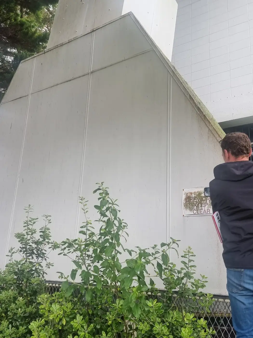SES supervisor inspecting the asbestos-cement ventilation hood during the pre-removal site visit