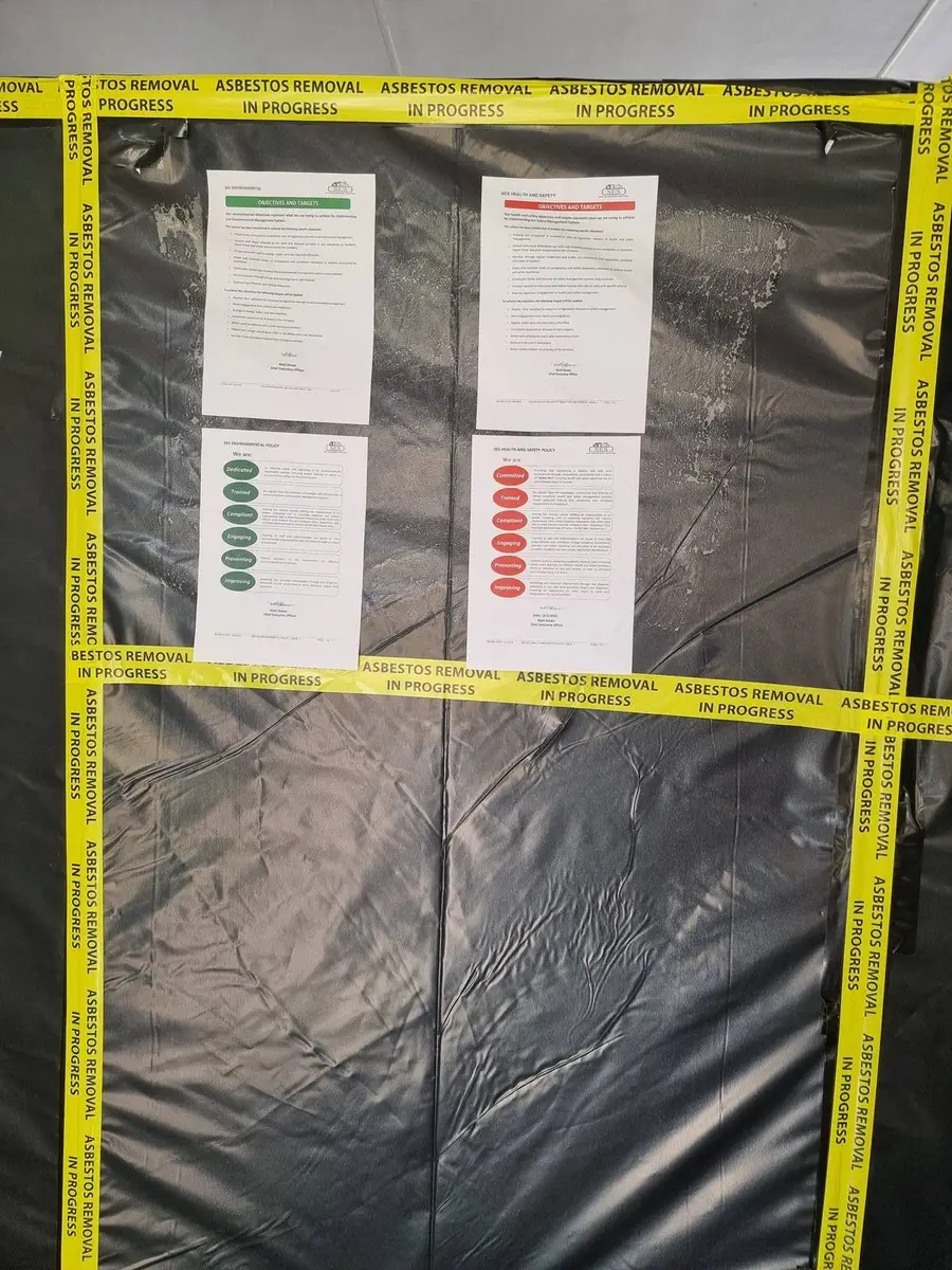 Asbestos control plan documents posted on the enclosure