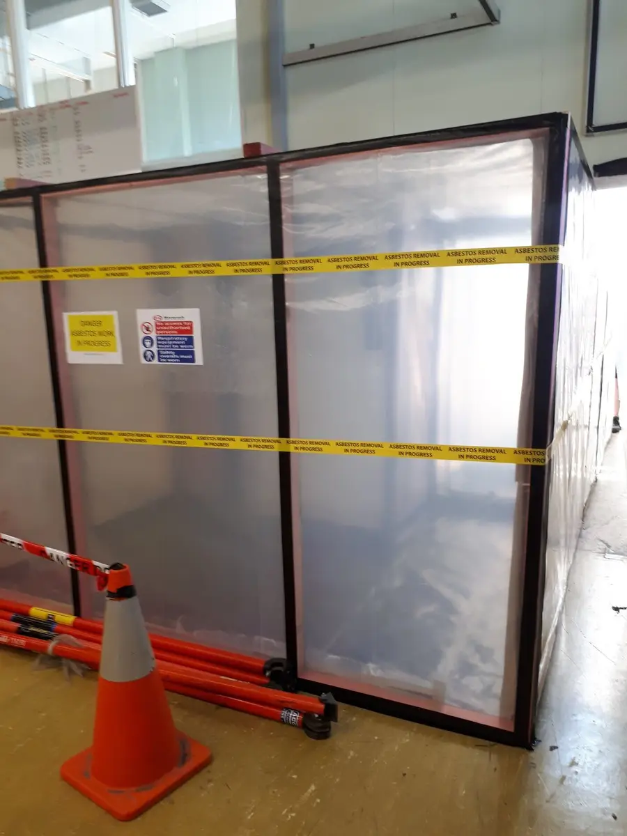 Asbestos enclosure with cones on a commercial floor