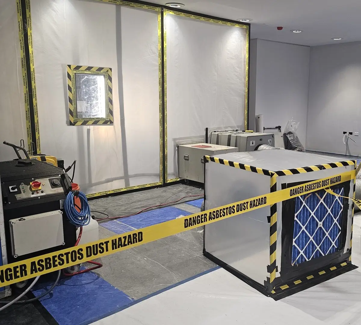 Asbestos enclosure with negative air units ahead of an office fit-out