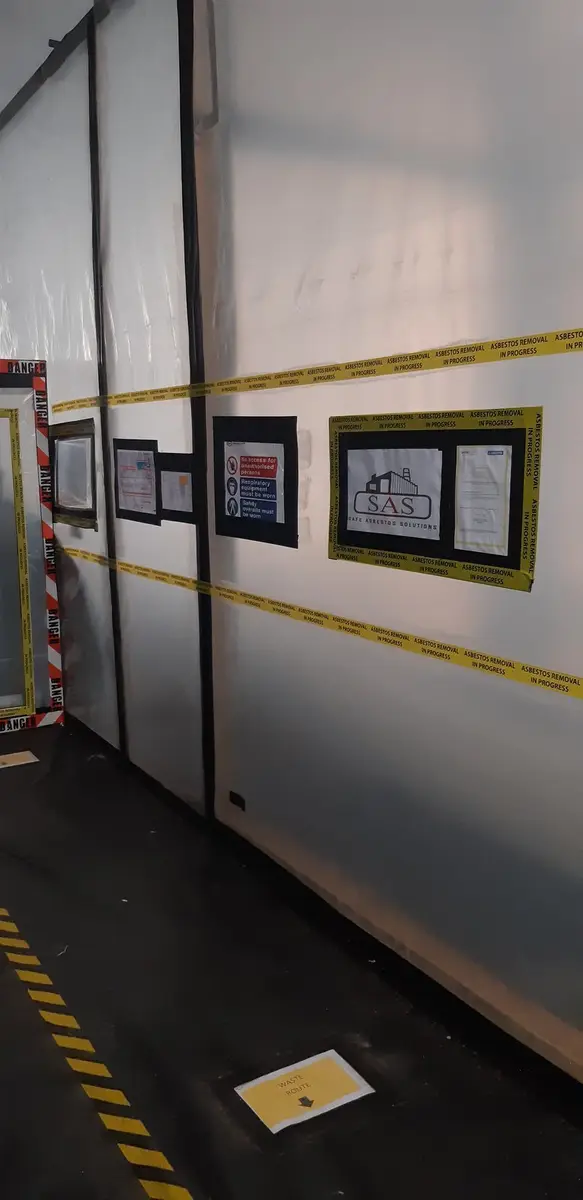 Enclosure wall sheeting at a commercial asbestos removal