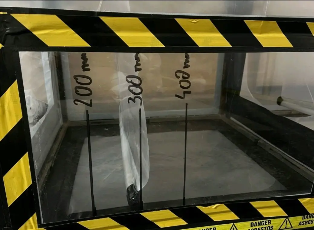 Asbestos hazard tape on enclosure equipment
