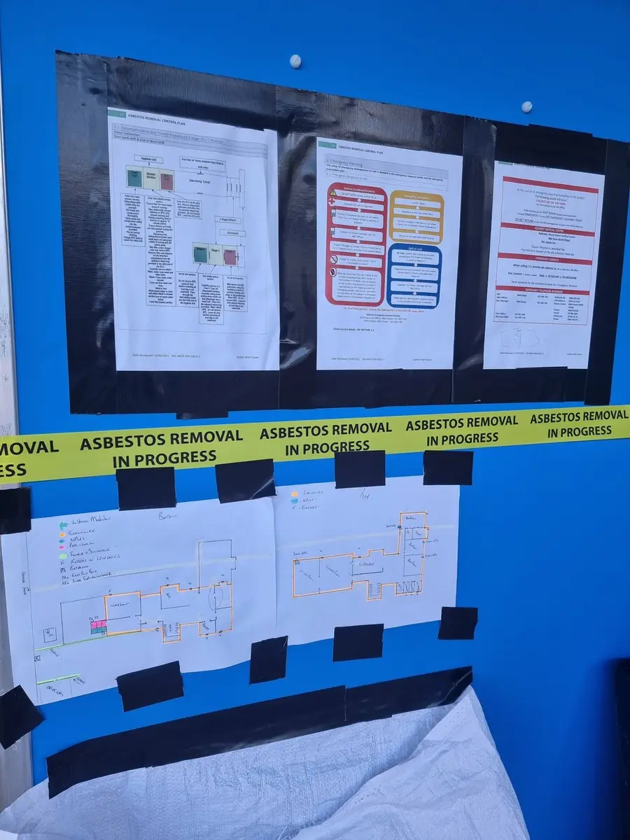 Asbestos removal control plan and site plan posted at the enclosure