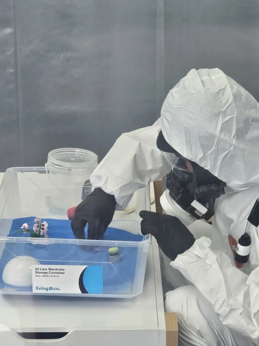 Sample handling with gloves and respirator during Class A asbestos removal