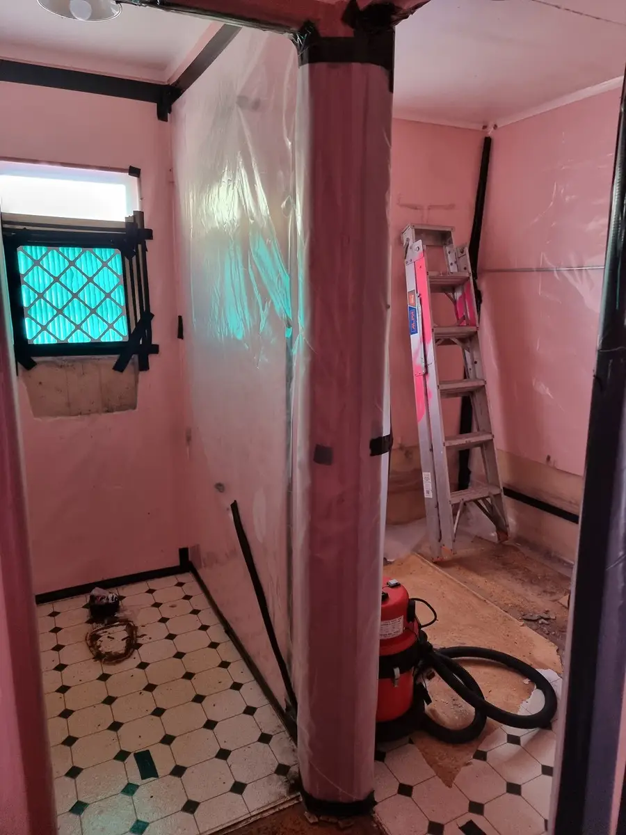 Bathroom sheeted as an asbestos enclosure in a house
