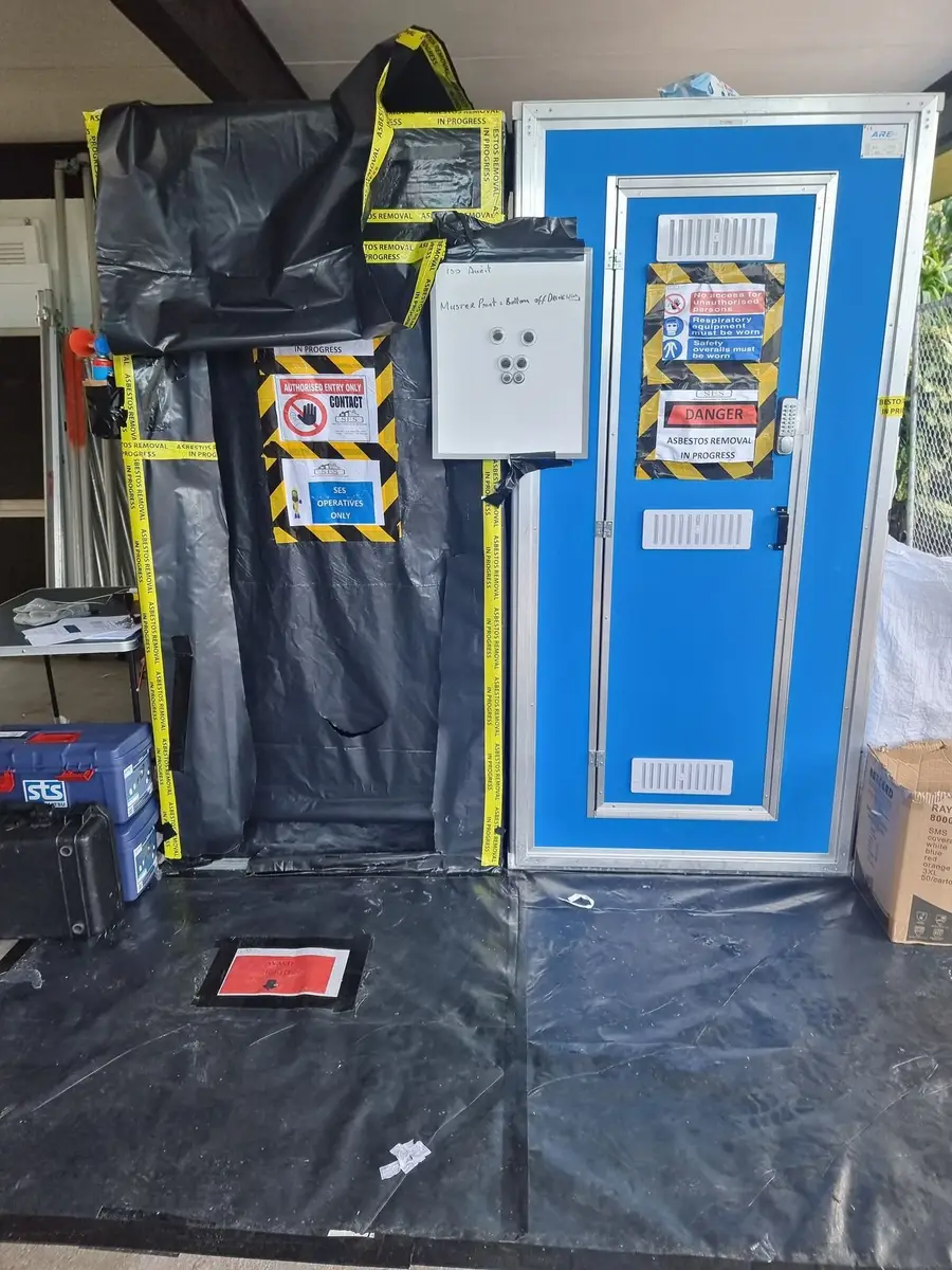 Black poly asbestos enclosure with decontamination unit entry