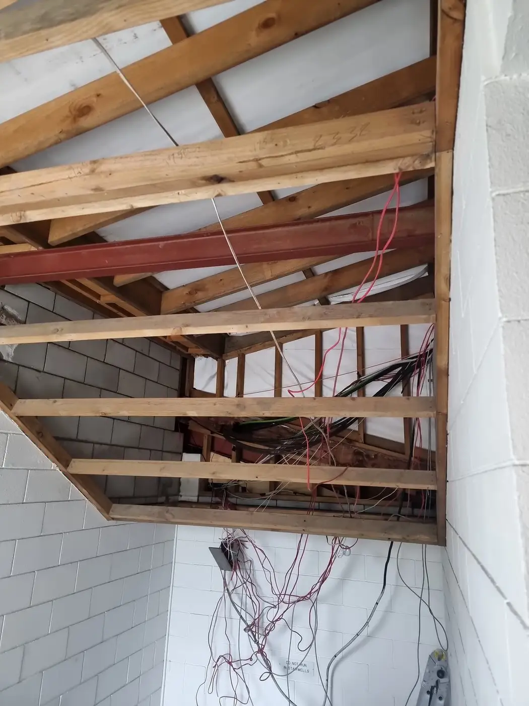 Ceiling framing and wiring exposed during the office strip-out