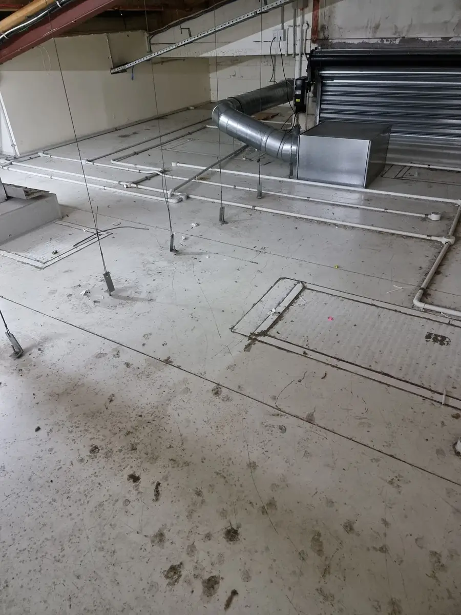 Asbestos-contaminated dust on the ceiling void floor before cleaning