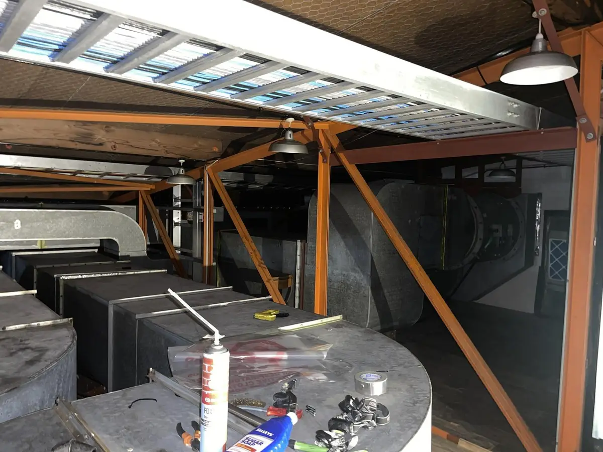 Ceiling void beams and ductwork seen from below