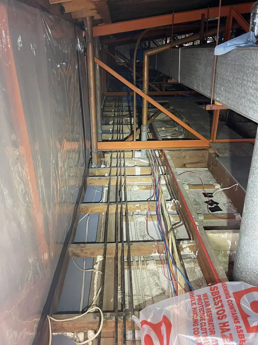 Ceiling void with danger asbestos signage during removal works