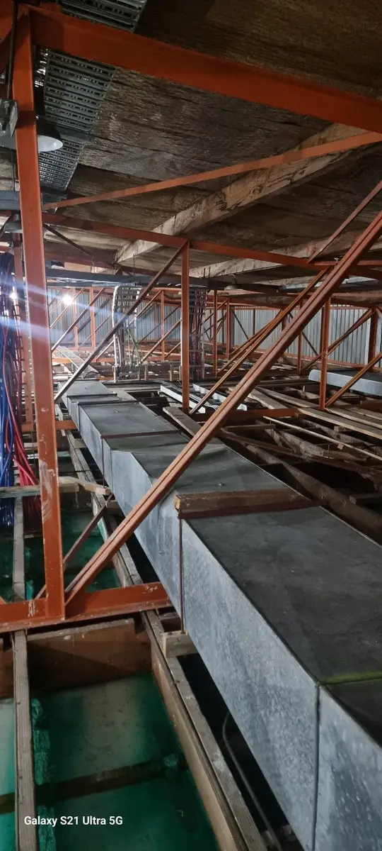 Ductwork beside a steel beam in the commercial ceiling void