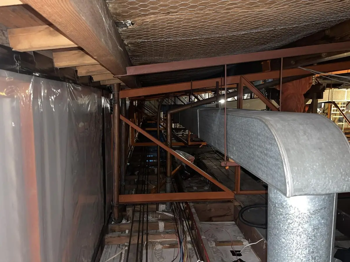 Ductwork in the ceiling void with asbestos removal in progress