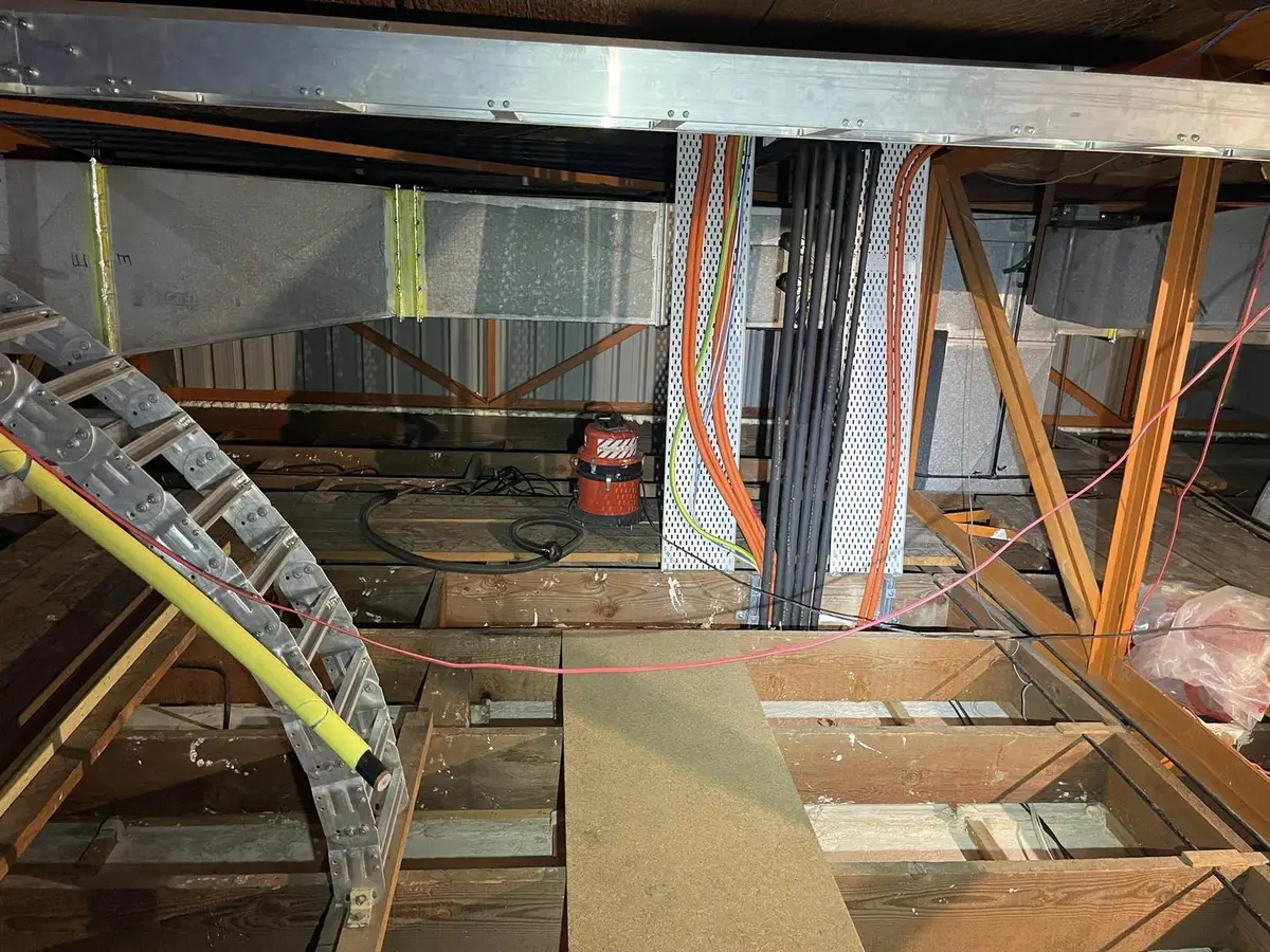 Steel beam and services in the ceiling void during asbestos removal