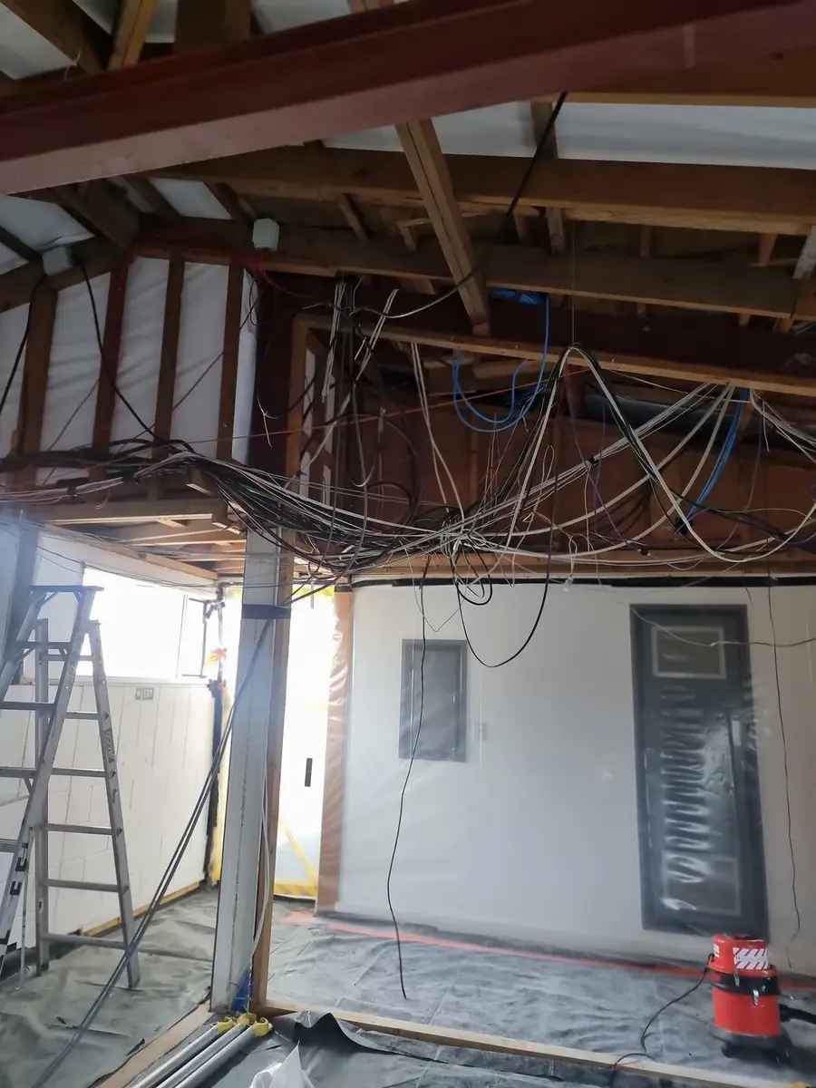 Ceiling wiring and framing with ladder during the office strip-out
