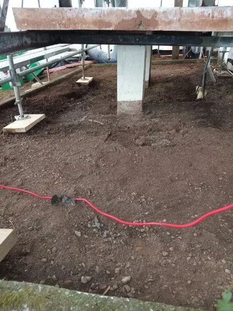 Cleared ground inside the scaffold enclosure after asbestos removal