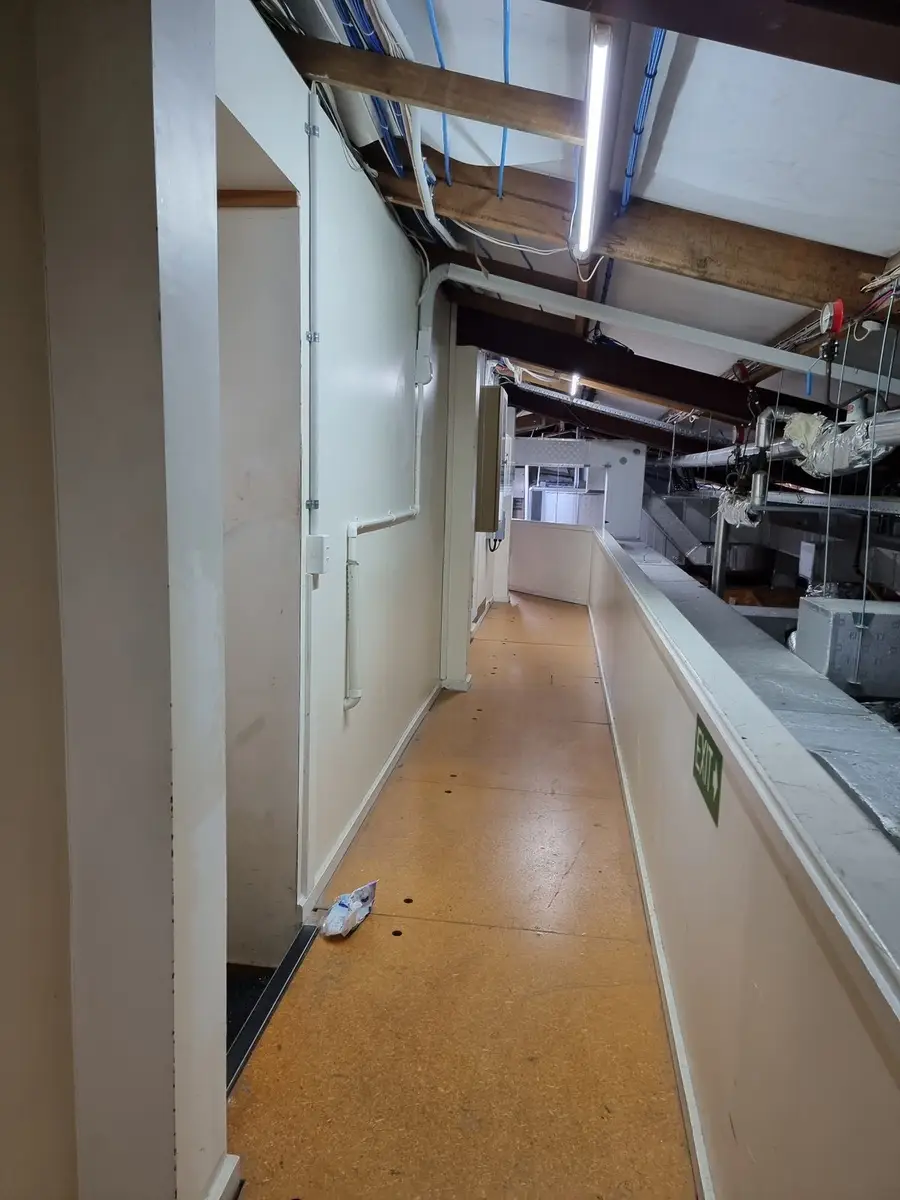 Commercial corridor with ceiling access during asbestos removal