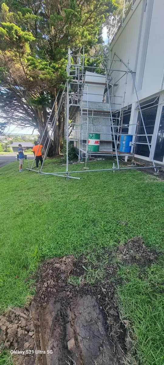 Lawn beside the commercial building being prepared for the asbestos structure removal