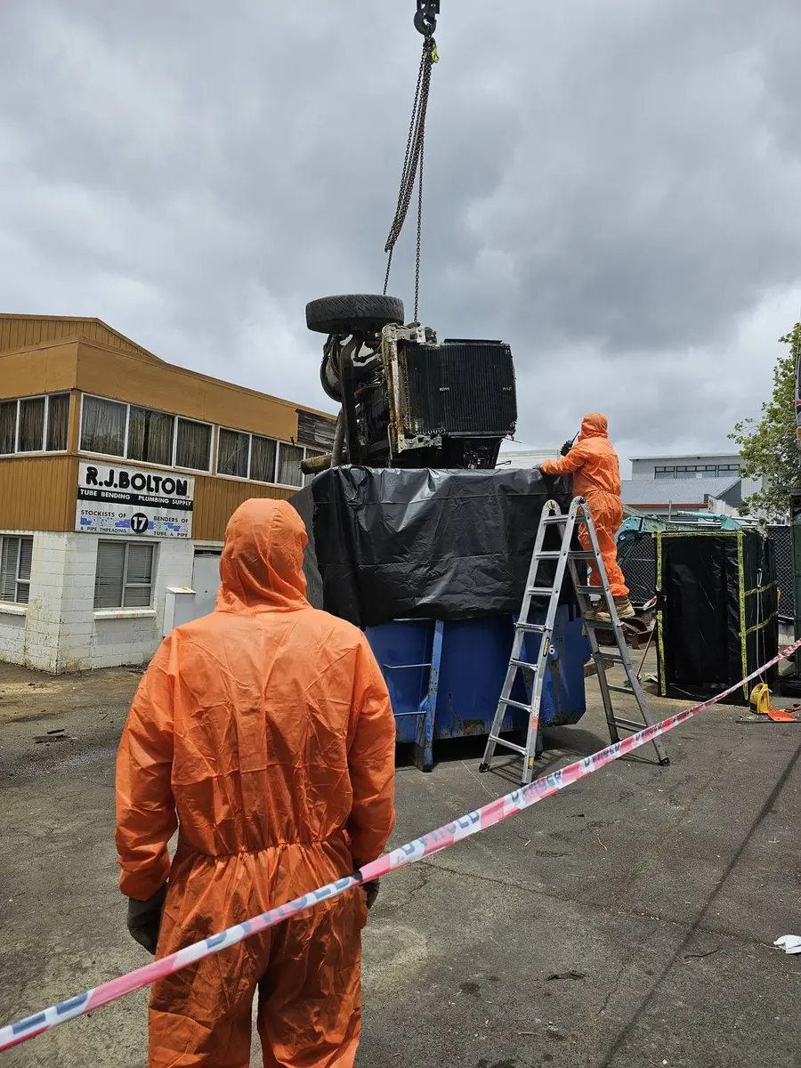 SES operative beside the lined bin with the contaminated plant inside