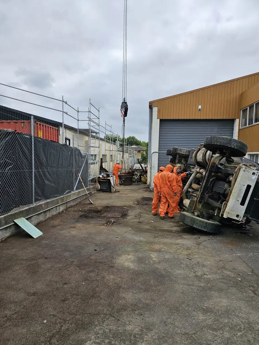 Contaminated plant on the ground with the SES crew in orange PPE