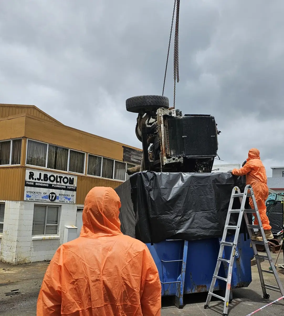 Contaminated plant in the lined bin being wrapped for licensed disposal