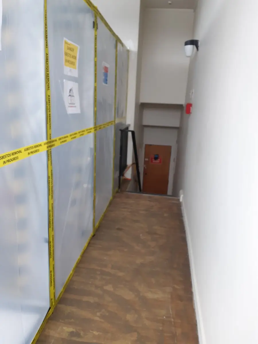 Sheeted corridor enclosure at a commercial asbestos removal
