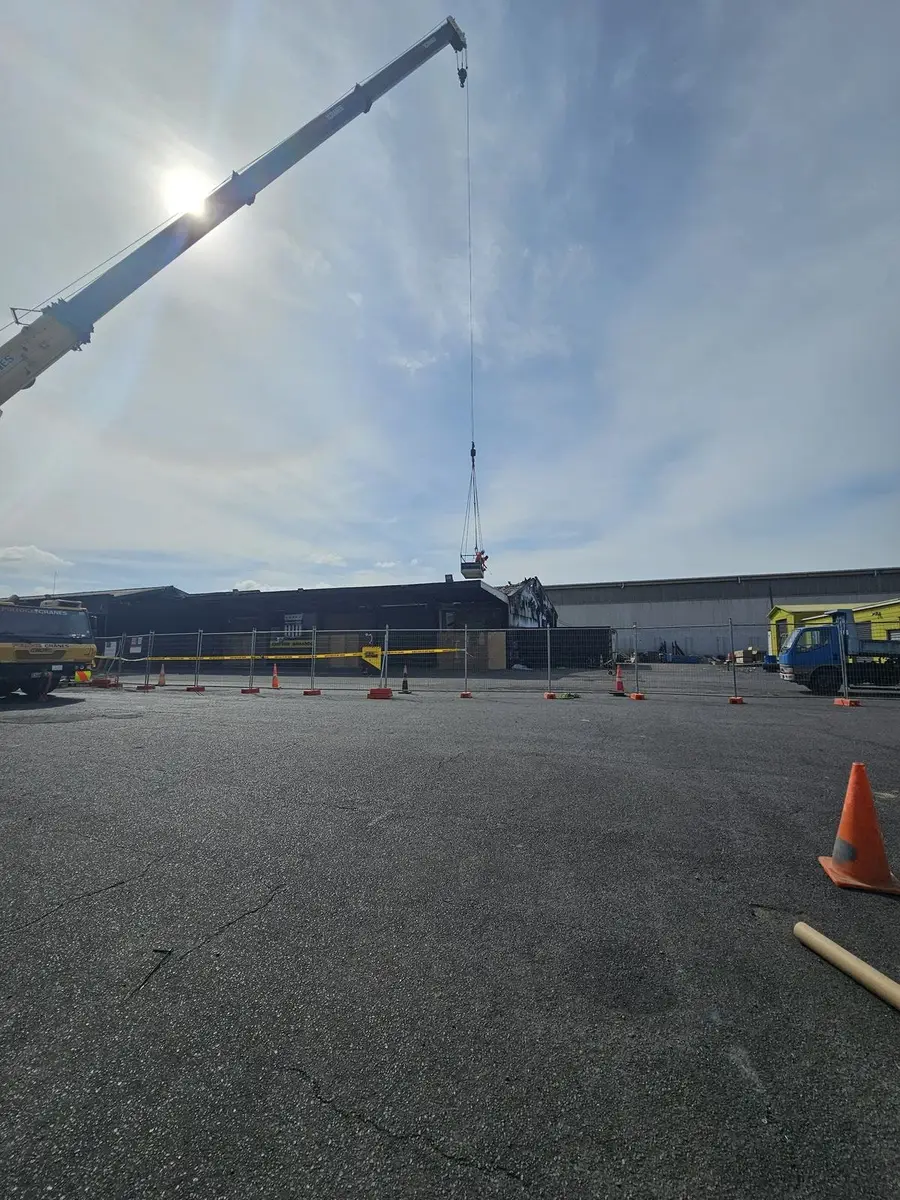 Crane boom over the car park during the asbestos roof removal