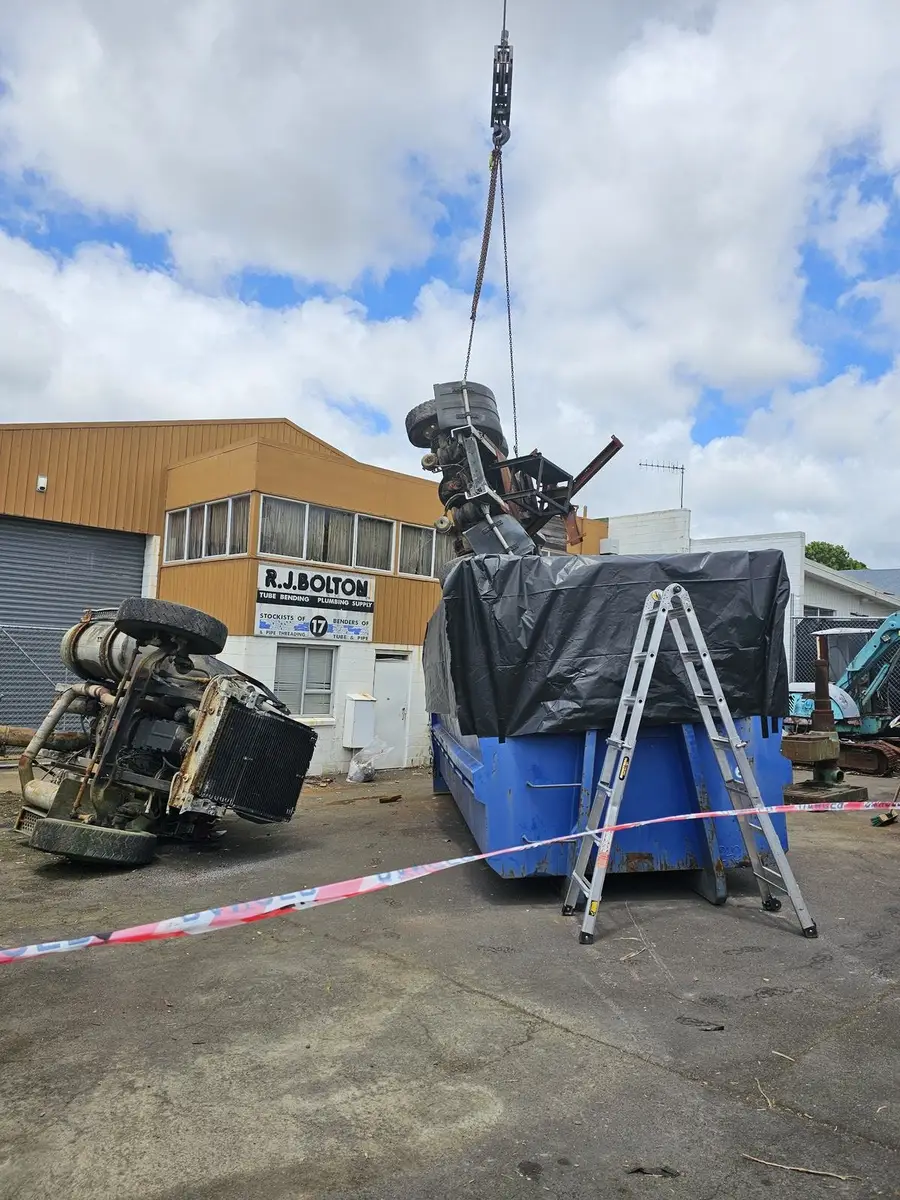 Crane placing the contaminated plant into the lined bin