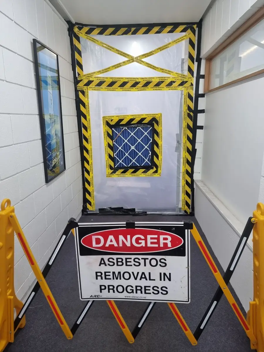 Danger asbestos sign and barrier at the corridor enclosure