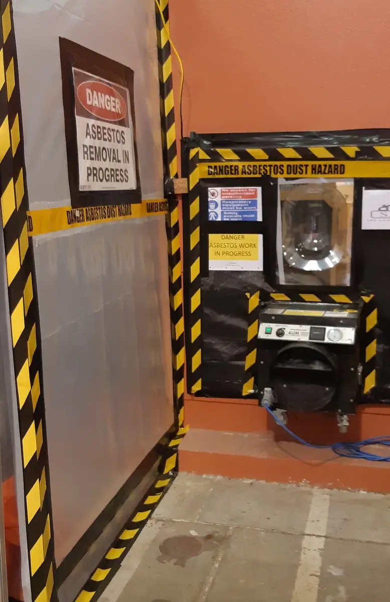 Danger asbestos signage and bag lock on the enclosure