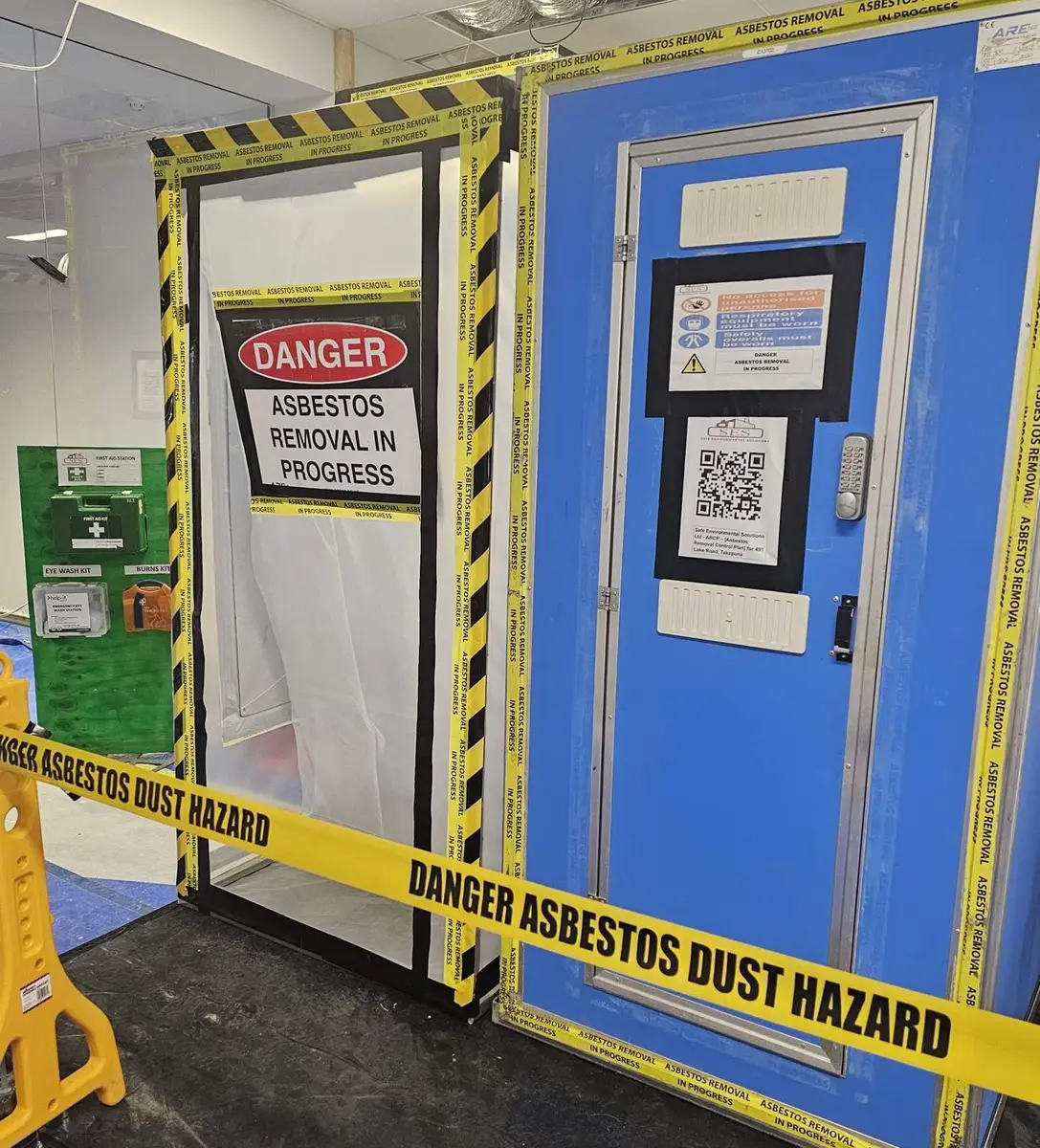 Decontamination unit door with danger asbestos removal sign in the office