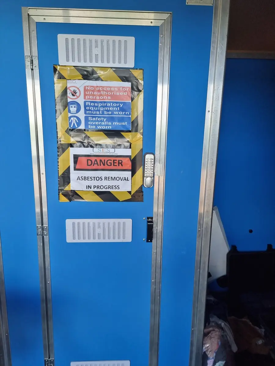 Close view of the decontamination unit door and signage