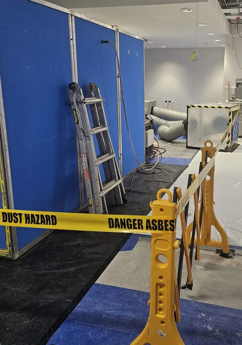 Decontamination unit, ladder and dust hazard tape in the office