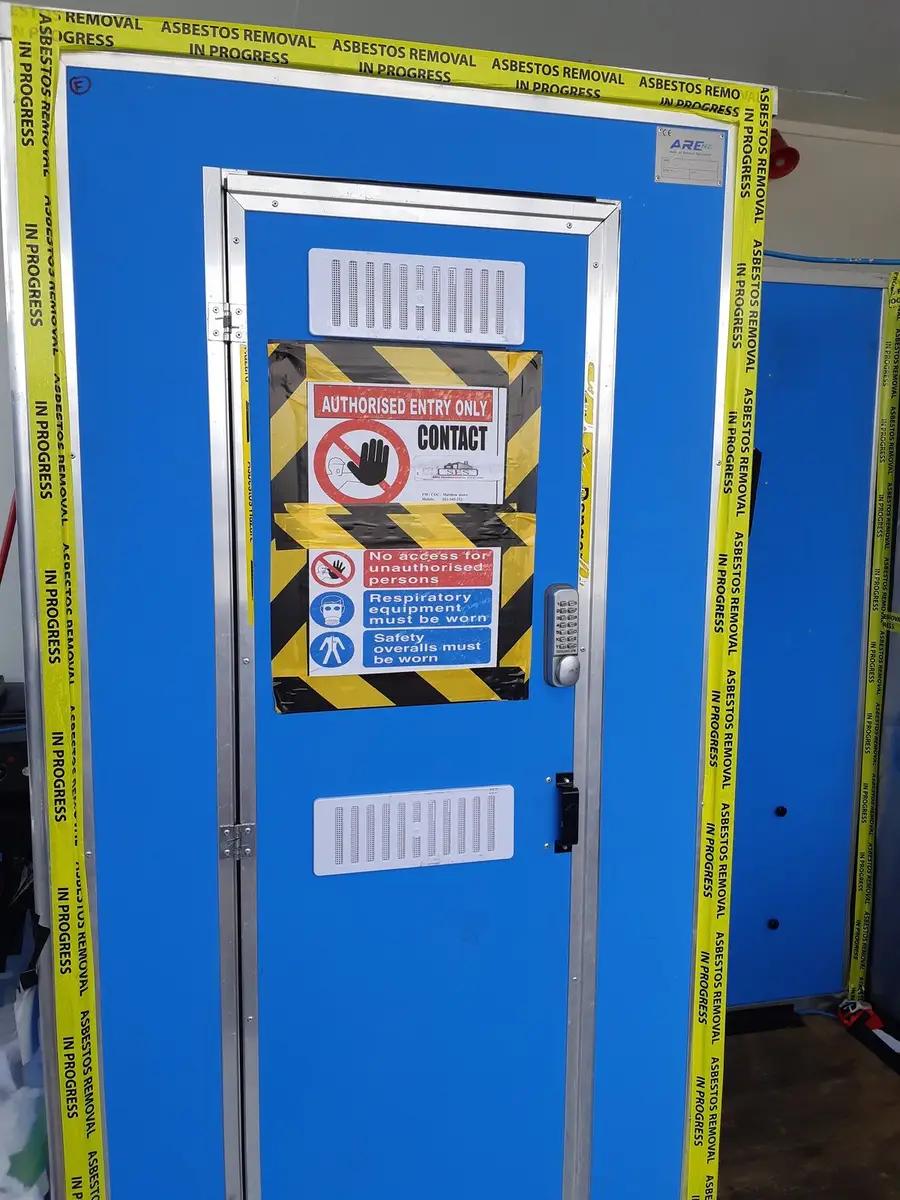 Decontamination unit door with signage at the commercial enclosure