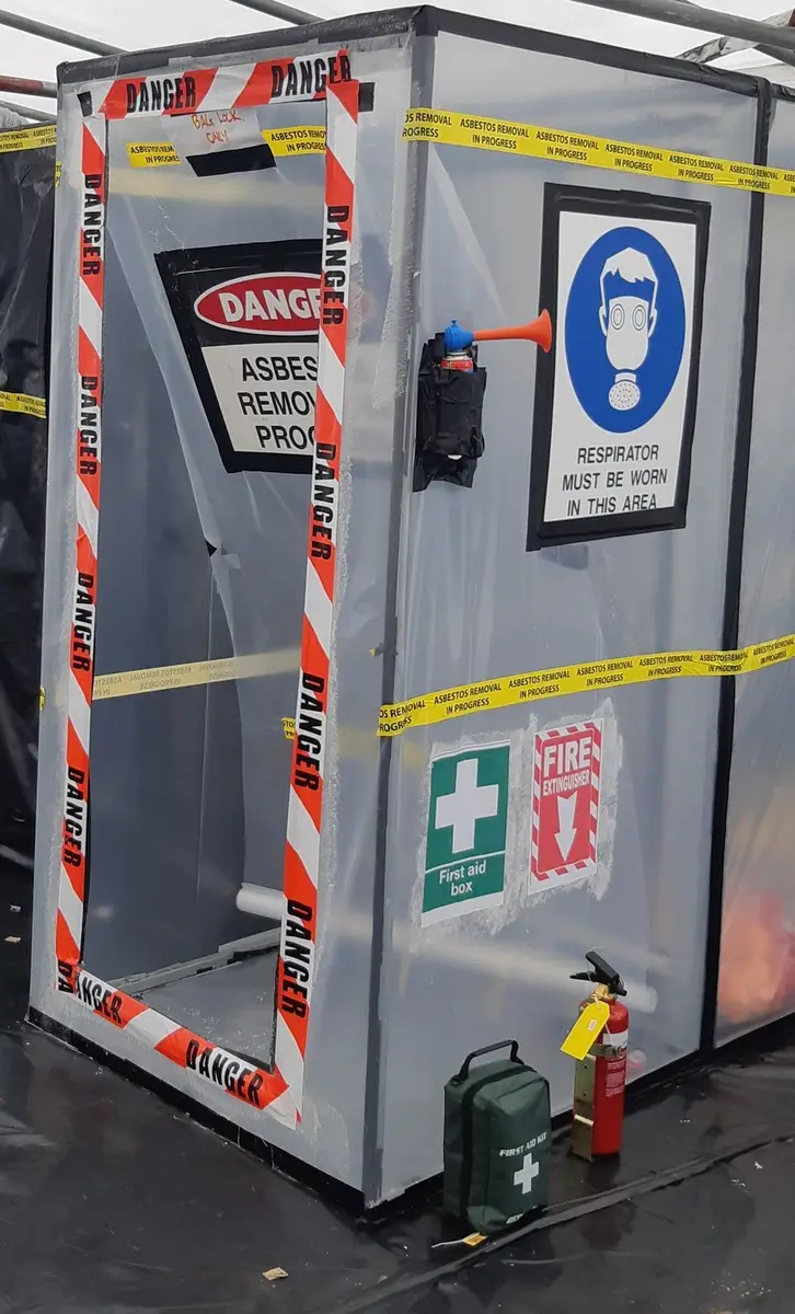 Decontamination unit with signage at a commercial asbestos job