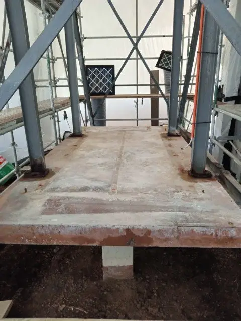 Base platform inside the enclosure after the asbestos-cement panels were removed