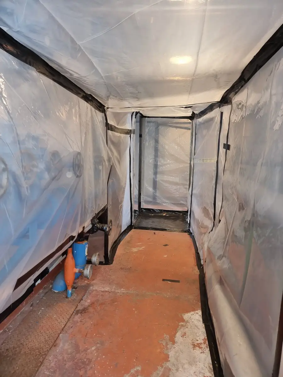 Enclosure corridor through the plant room during lagging removal