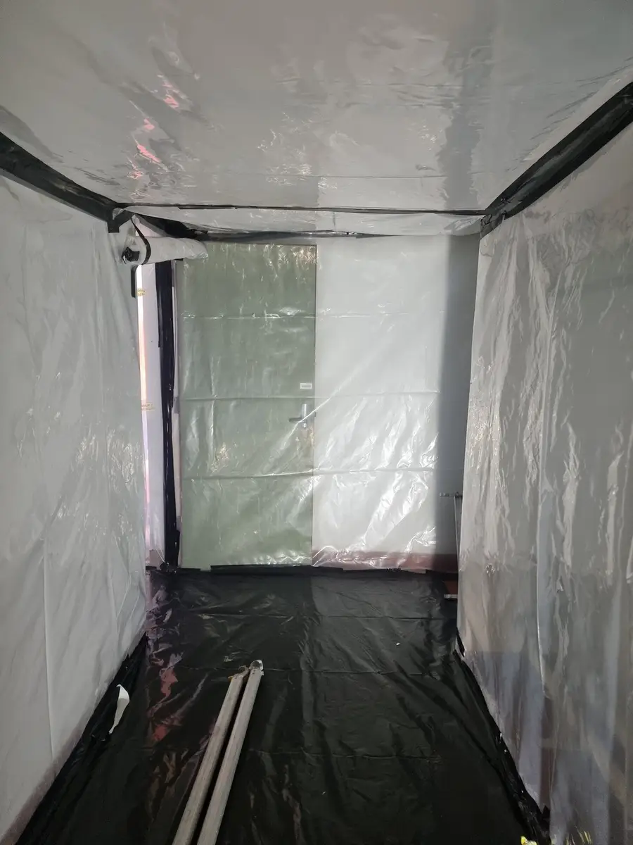 Poly-sheeted tunnel inside the asbestos enclosure