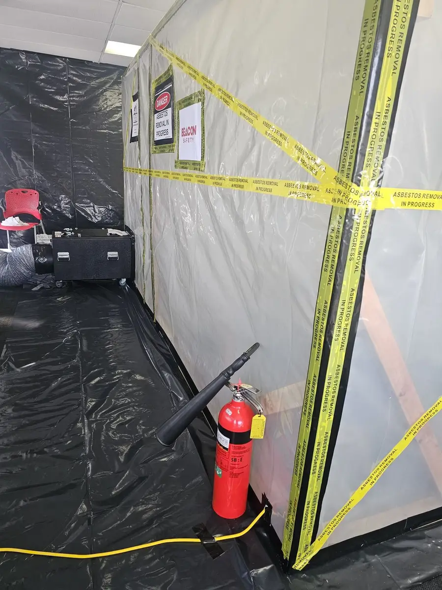Fire extinguisher positioned at the asbestos enclosure as part of site safety