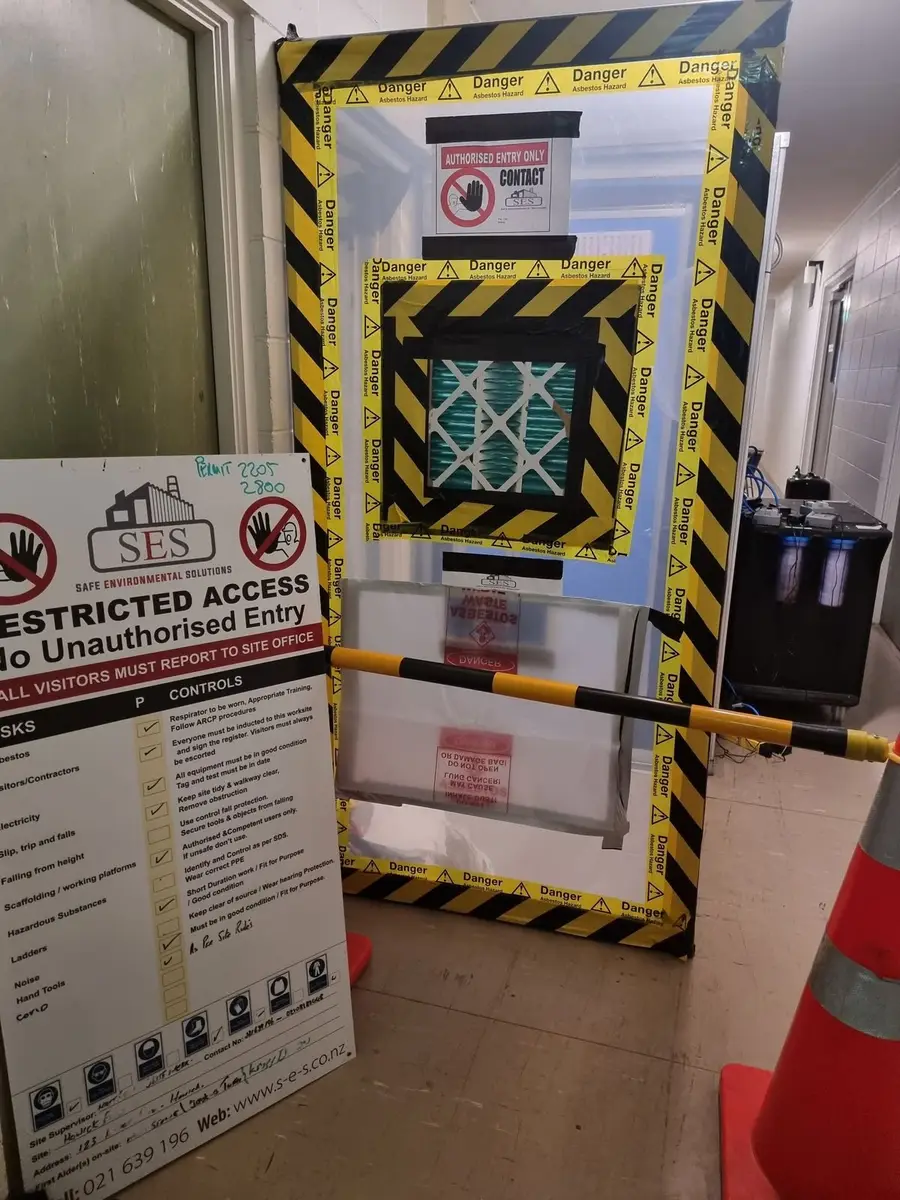 HEPA air inlet in the enclosure wall with restricted access sign