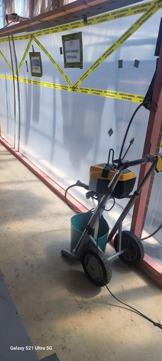 HEPA vacuum at the enclosure entry in the office corridor