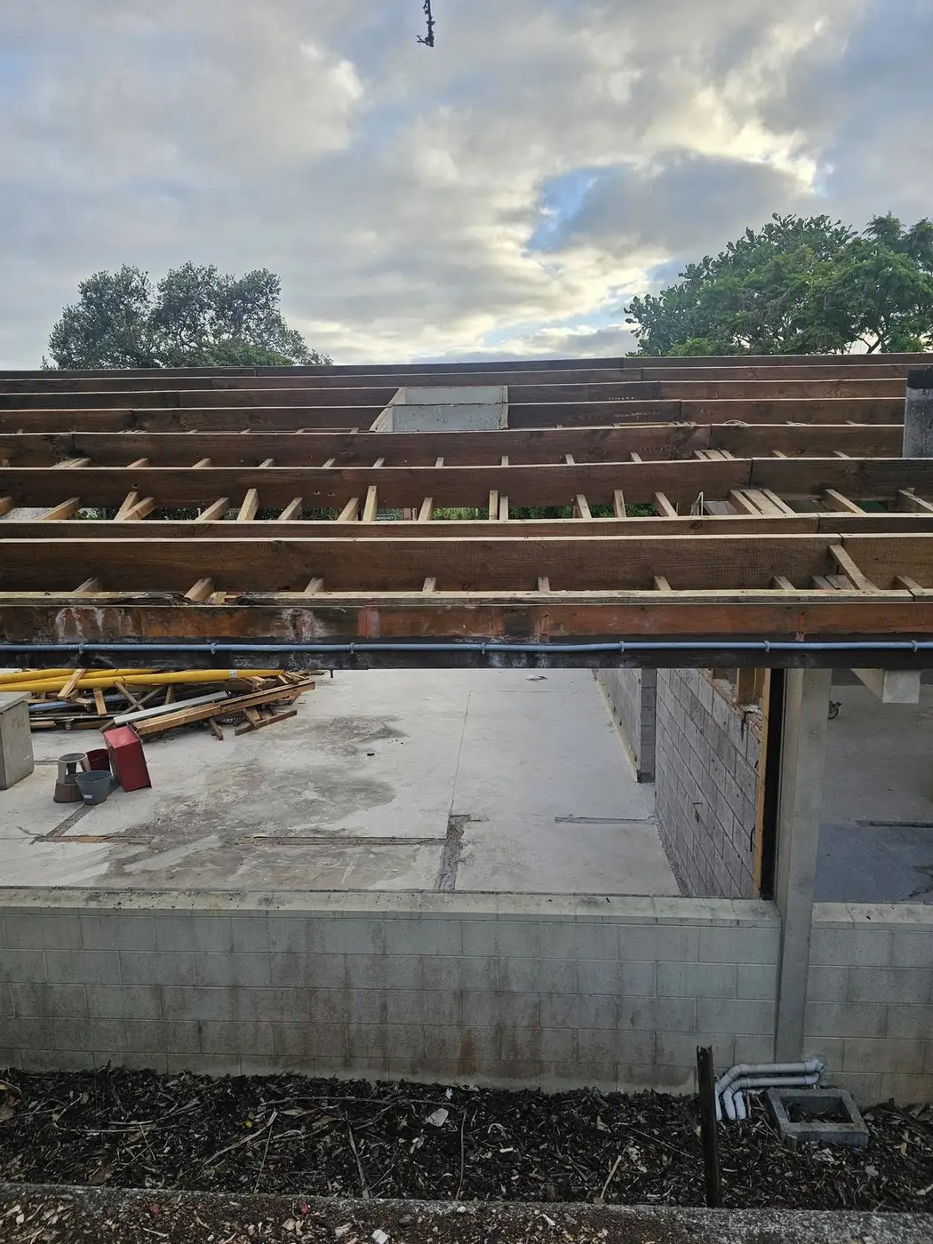 House deconstruction with the roof removed and framing exposed