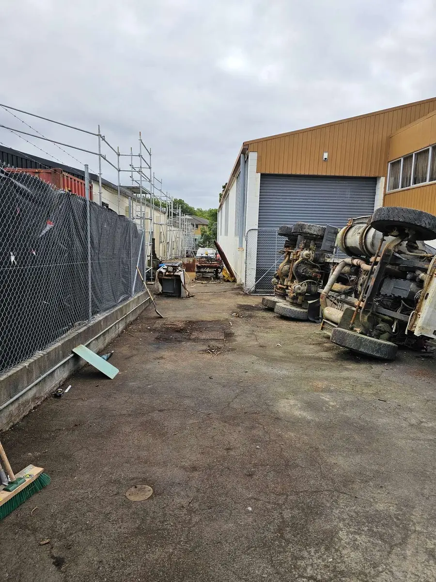 Fenced industrial yard with the contaminated plant before lifting