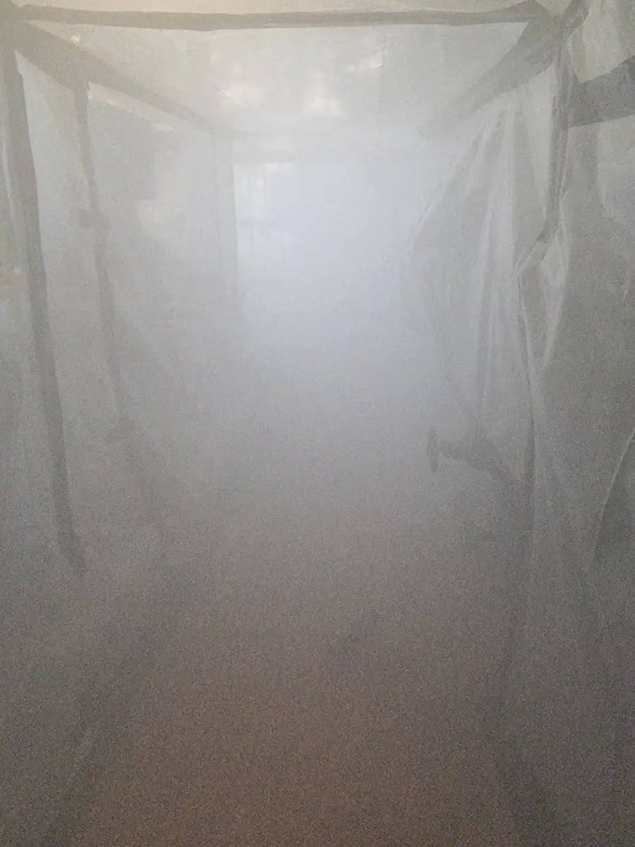 Inside the enclosure during wet spray suppression in the plant room