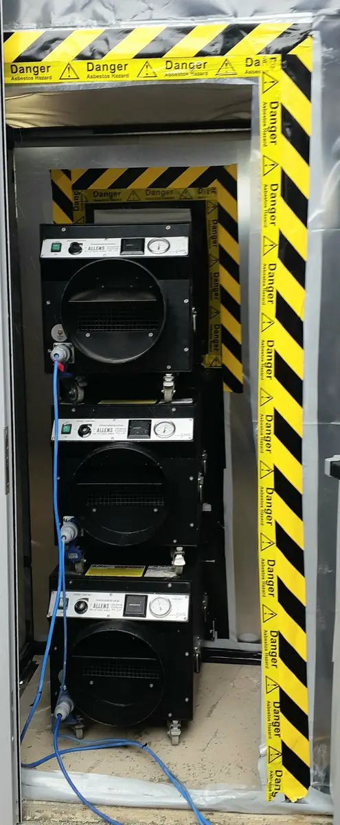 Negative air units at the enclosure entry on the industrial site
