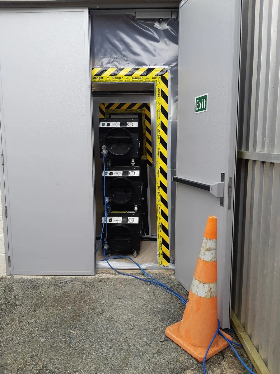 Negative air units stacked at the industrial asbestos enclosure