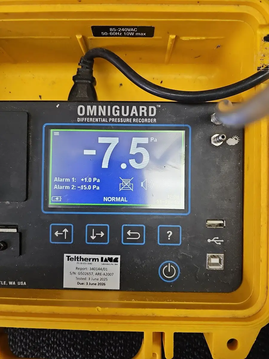 Differential pressure recorder showing negative pressure inside an SES asbestos enclosure
